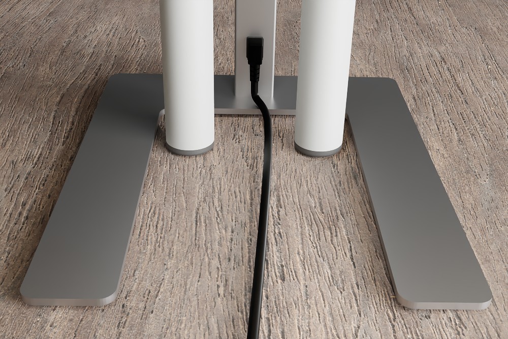 Der Standfuß in U-Form umschließt beide Tischbeine bei einer Blockstellung. Das Netzkabel befindet sich an der Bedienseite und ist somit keine Stolperfalle. Abbildung: Novus